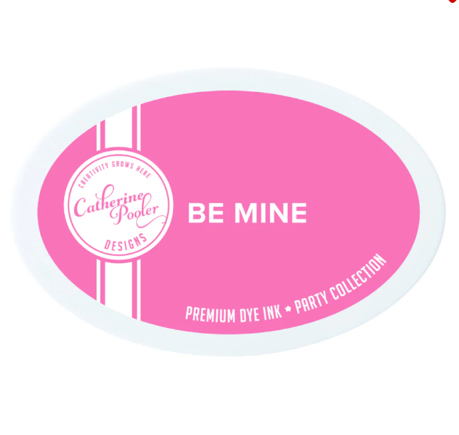 Pink ink pad with 'Be Mine' text and Catherine Pooler Designs branding on a white background